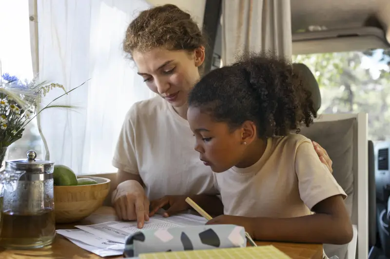 Mother helping her daughter with school translation materials